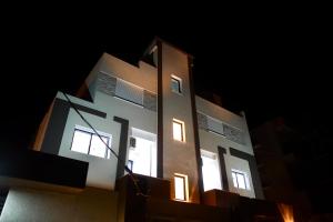 a building with lights on it at night at Résidence Sana in Mahdia