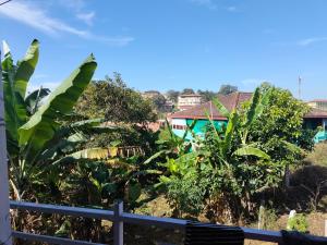 a view of a village with trees and houses at Laharya couple room in Madikeri
