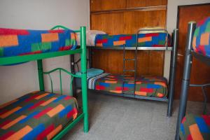 a room with two bunk beds and a ladder at Hostel Trotamundos in San Juan