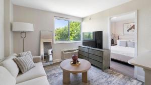 a living room with a couch and a bed at Landing Apartments - St Petersburg in St Petersburg