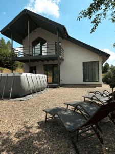 a building with a group of chairs in front of it at TiERRA in Slavske
