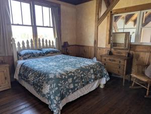 a bedroom with a bed and a dresser and a mirror at Breathtaking Cabin Away From Reality in Clark