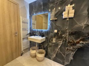 a bathroom with a sink and a mirror at Filippos House in Preveza +22 photos