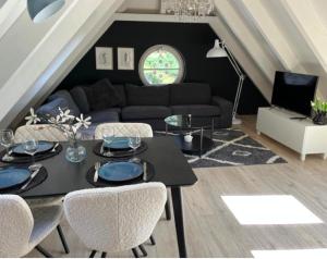 a living room with a black table and chairs at De Reesterhoeve in Balkbrug