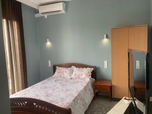 a bedroom with a bed and a television in it at Belle Vue in Tlemcen