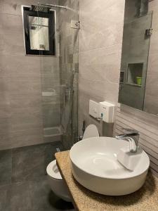 a bathroom with a sink and a toilet at Belle Vue in Tlemcen