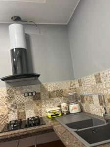 a kitchen counter with a sink and a stove at Belle Vue in Tlemcen +8 photos