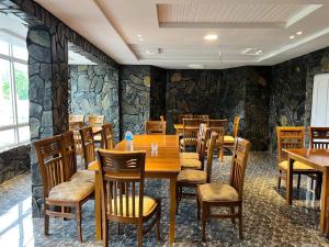 ein Esszimmer mit einem Holztisch und Stühlen in der Unterkunft Orophile Nest And Resturent in Skardu
