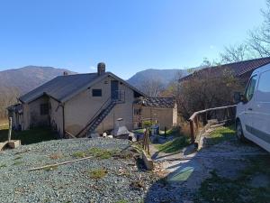 a van parked in front of a house at Il Rifugio della Baita in Viù