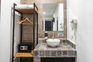 a bathroom with a sink and a mirror at Capital Hotel Saltillo in Saltillo +20 photos