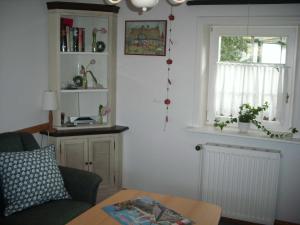 a living room with a couch and a window at Ahlborns Bluetenhof in Jork +7 photos