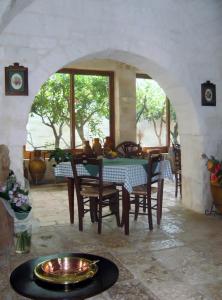 a dining room with a table and chairs in a room at Masseria Asciano in Ostuni
