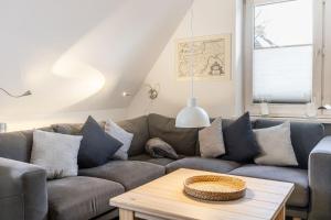 a living room with a couch and a table at Wohnung 4 ID 152 in Sankt Peter-Ording
