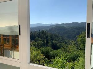 a window view of the mountains from a house at Casa do Carpinteiro in Crecíente
