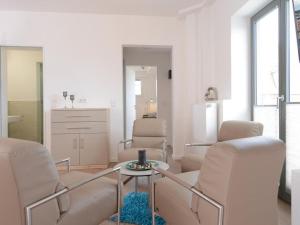 a living room with two chairs and a table at Ohlerich Speicher App_ 05 in Wismar