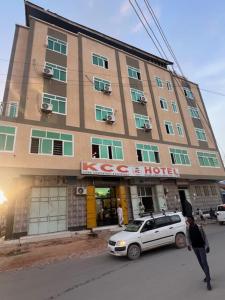 a white car parked in front of a building at Kcc hotel and Restaurant 