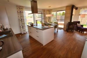 a kitchen with a island in the middle of a room at VILLA AQUILA _ EG_Fewo in Göhren-Lebbin