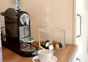 a coffee maker and a cup on a table at VILLA AQUILA _ EG_Fewo in Göhren-Lebbin +13 photos