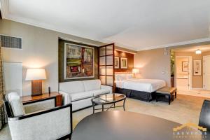 a hotel room with a bed and a couch at MGM Signature-07-703 Strip View Jacuzzi Studio in Las Vegas