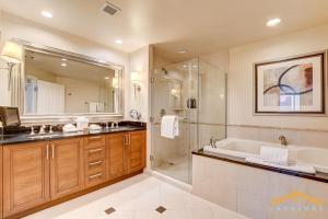 a bathroom with a tub and a shower and a sink at MGM Signature-07-703 Strip View Jacuzzi Studio in Las Vegas