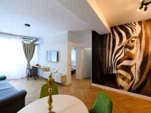 a living room with a zebra painting on the wall at Aparthotel Madonna Residence Petunilor in Craiova