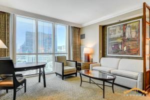 a living room with a couch and a table at MGM Signature-07-703 Strip View Jacuzzi Studio in Las Vegas
