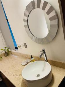 a bathroom sink with a large mirror above it at Northtown San Ramón in Mérida