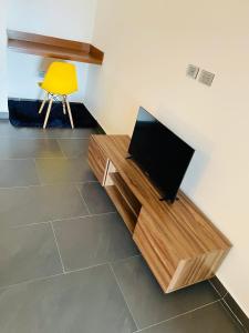 a television sitting on a wooden stand in a room at Northtown San Ramón in Mérida
