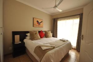 a bedroom with a large bed with a window at Eden Cottage in White River