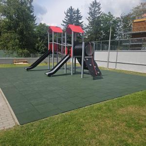 a playground with two slides on the grass at Stone Hill Szklarska Poręba in Szklarska Poręba +50 photos