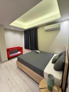 a bedroom with a large bed and a red table at PERFECT APPART Grand Baie Centre Next To Super U, 5 Minutes from beach in Grand Baie