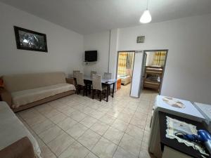 a living room with a couch and a table at Ramadani Apartments in Velipojë