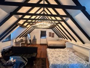 a attic room with two beds and a couch at Studio Apartment in Smithtown