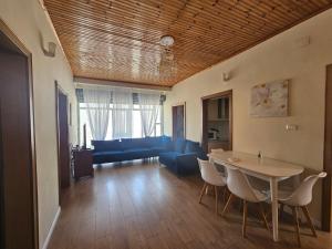 a living room with a table and a blue couch at La Piscina in Shkodër