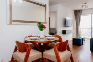 a dining room with a table and chairs and a room with a window at 3BR Pool & Gyw in Lima +88 photos
