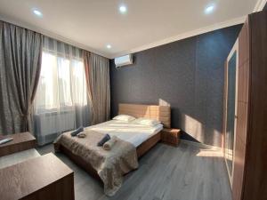 a bedroom with a bed and a large window at Twin villas VSL in Gabala +8 photos