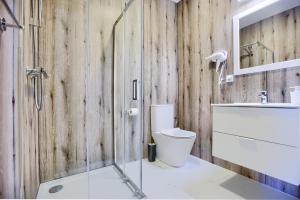 a bathroom with a shower and a toilet and a sink at TaaakaRyba in Kołobrzeg