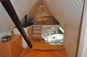 a attic room with a bunk bed and a kitchen at Ferienwohnungen Alte Maar 65330 in Moormerland