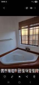 a bath tub in a bathroom with a window at 33 On Loop, Flat 1 in Ladybrand +19 photos