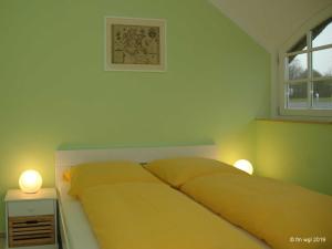 Ein Bett oder Betten in einem Zimmer der Unterkunft Landhaus Uhlenhof 4