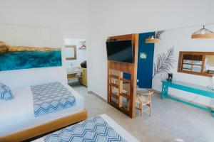 a bedroom with a bed and a desk at Buena Vista Oceanfront & Hot Springs Resort in Buenavista