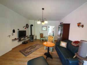 a living room with a couch and a table at Ferienwohnung Am Traumgarten, 35646 in Uplengen