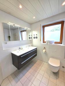 a bathroom with a sink and a toilet and a mirror at Residenz Cheval - BOHO - Ravensburg - Bodensee in Ravensburg +33 photos