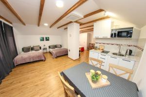 una cucina e un soggiorno con tavolo e sedie di Studio apartman HBB a Sarajevo