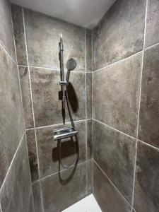a shower with a shower head in a bathroom at Nuit romantique en Provence in Draguignan