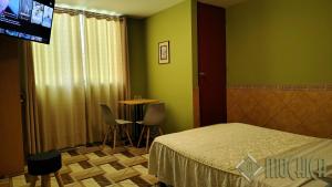 Postel nebo postele na pokoji v ubytování Hostal Residencial Mochica