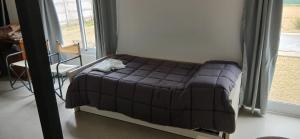 a small bed in a room with a window at El Contenedor Premium in San Francisco +15 photos