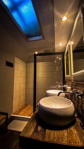 a bathroom with a round sink and a tub at TREE LODGE CHILOE in Puqueldón +35 photos