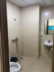 a bathroom with a shower and a toilet and a sink at Mường Thanh Viễn Triều - Hồ Tiên Apartment in Nha Trang