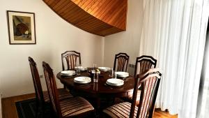 a dining room table with chairs and a wooden table at Balkan Vibe Apartments in Žabljak